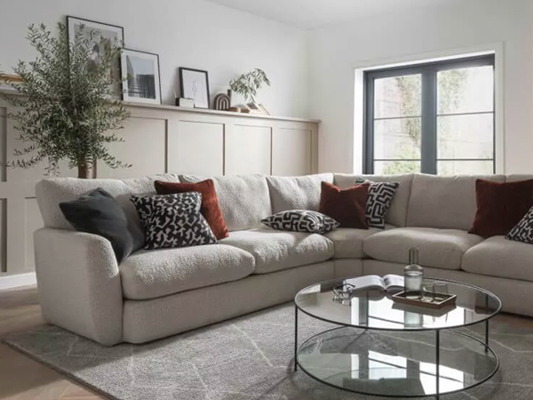 A corner sofa and glass table